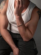 silver bracelet on a male models wrist
