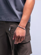 silver bracelet on a male model's wrist